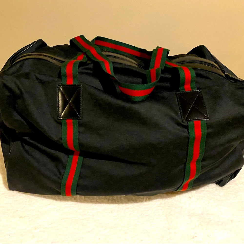 Collapsible GUCCI duffle bag with storage bag.